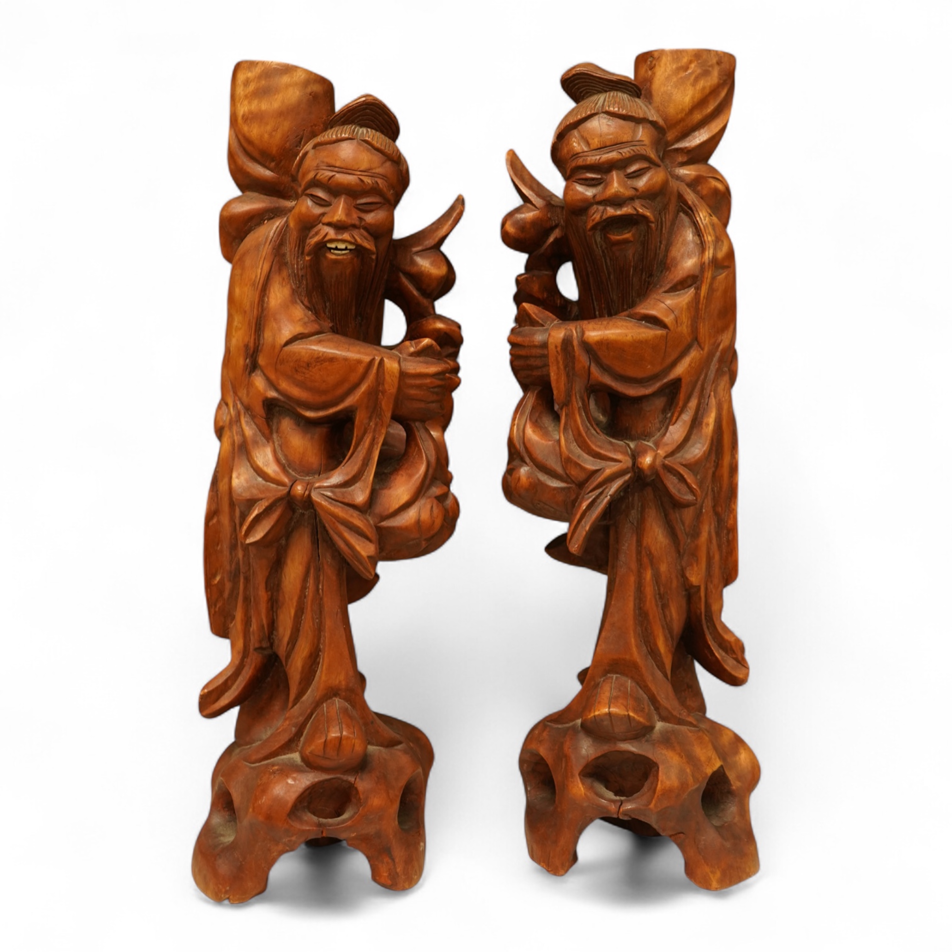 A pair of 20th century Chinese carved wood figures of sages, 31cm